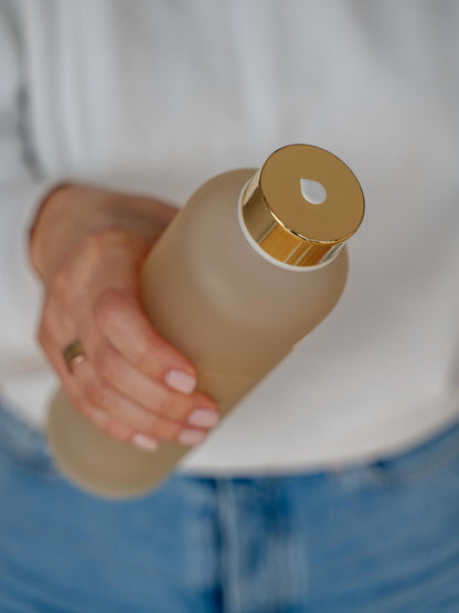 Girl holding glass water bottle Mismatch Ginkgo in her right hand