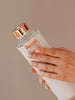 Holding Mismatch Lava glass bottle with marble faux leather cover and rose gold lid