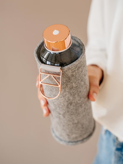 Holding Mismatch Rose Gold glass bottle with rose gold lid 