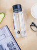 EQUA BPA FREE water bottle, Plain Black, on the dinning table, together with coffee, reading glasses and a magazine, minimalistic design, no motif, black