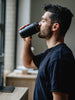 Men drinking from coffee cup, the EQUA Cup Black